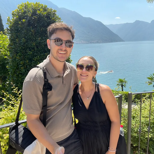 Benjamin and Danielle overlooking a lake and mountains on a sunny day