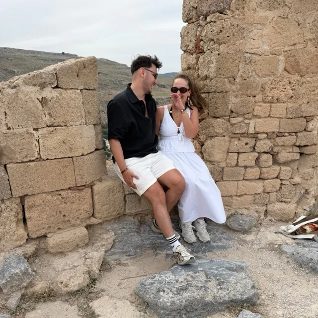 Benjamin and Danielle sitting on old stone ruins
